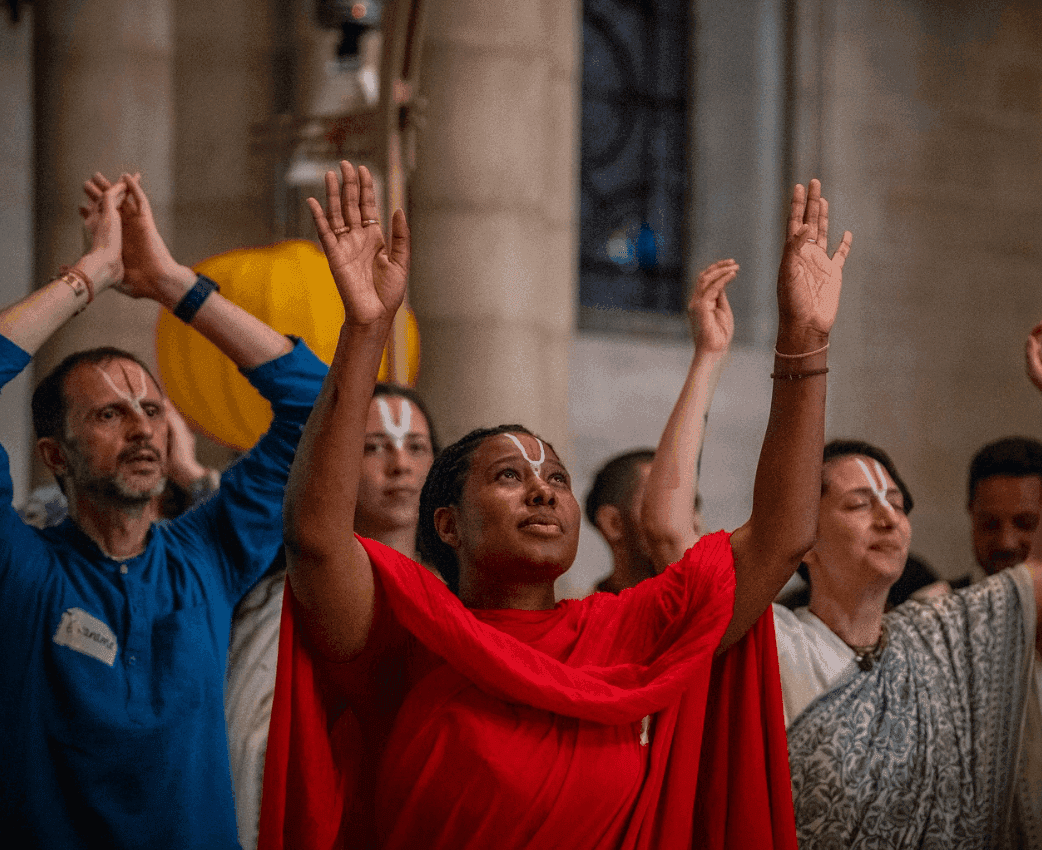 Devotees dancing and celebrating during kirtan